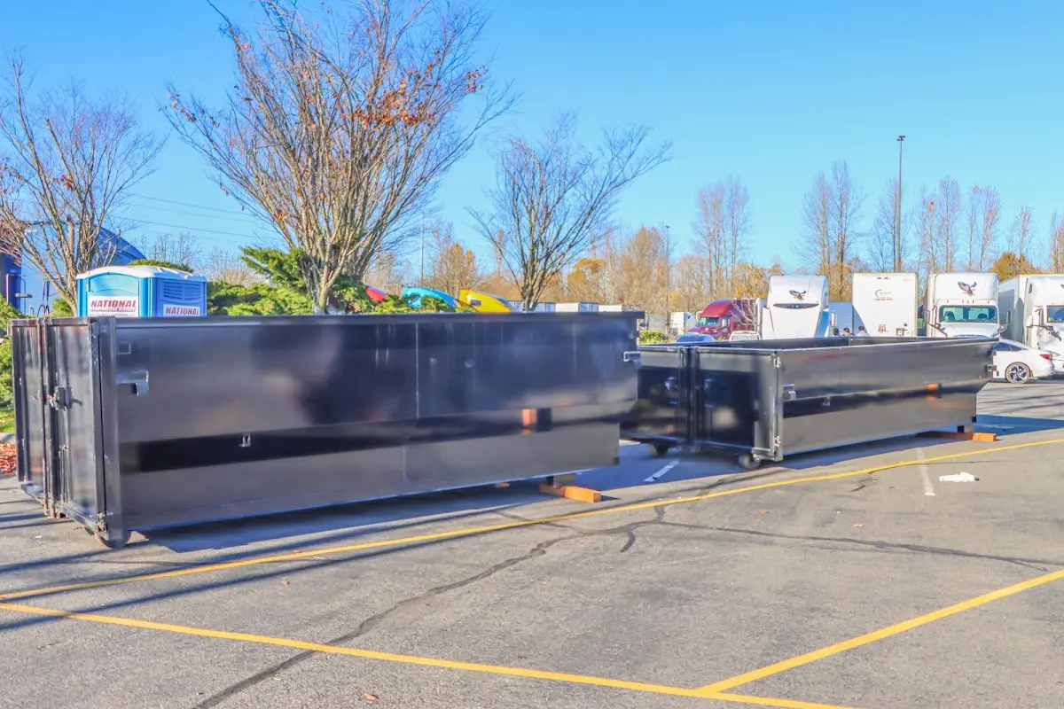 Professional dumpster rental service with roll-off container on residential driveway in Leonia